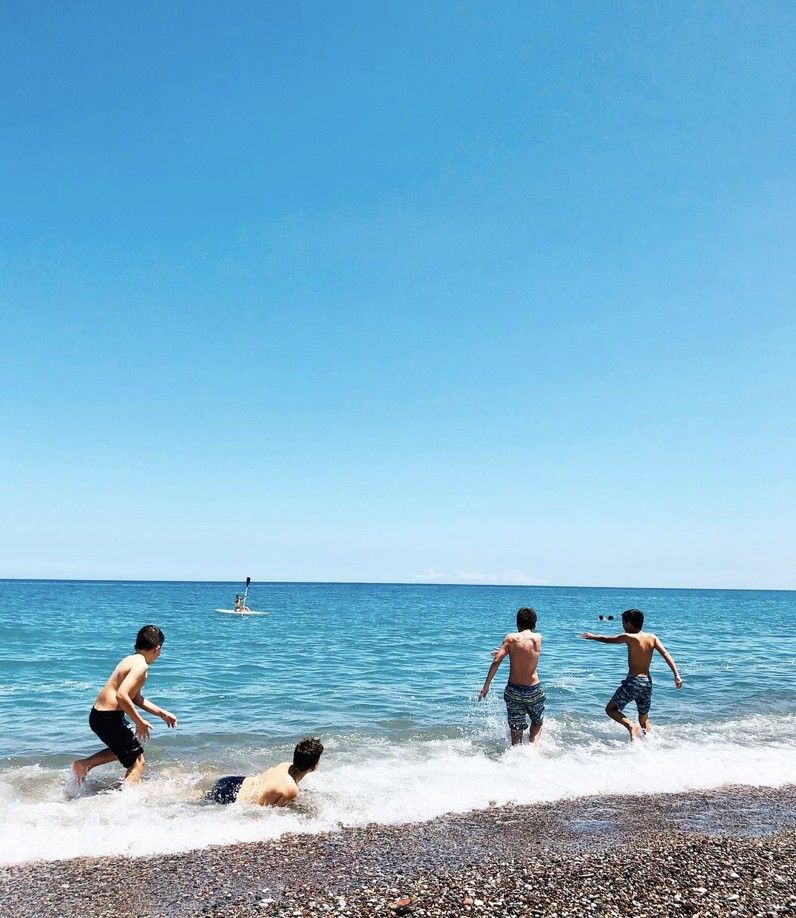 Kids playing on the waves